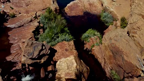 Aerial swoop over river and natural rock pools on a sunny day Stock Footage