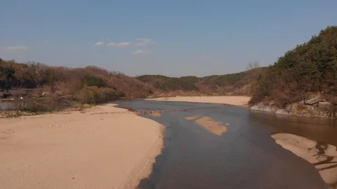 Aerial takeover of tiny wooden bridge above the river Stock Footage 110960952