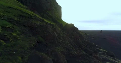 Aerial of tall cliffs overlooking beach during sunrise 스톡 동영상 79838981
