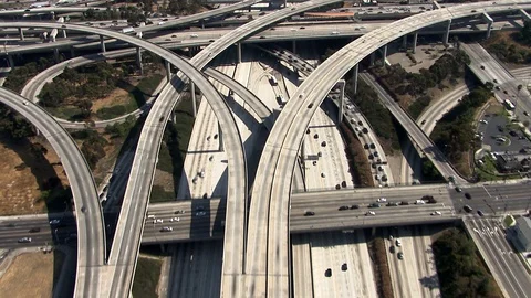 Aerial of tangled freeway interchange vehicles driving in every direction Stock Footage 106203120