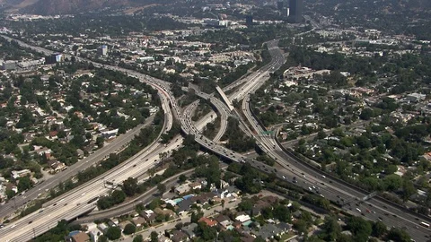 Aerial of tangled freeway interchange vehicles driving in every direction Stock Footage