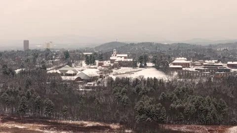 Aerial telephoto pullback as snow falls over Amherst College, Western Stock Footage 331274769
