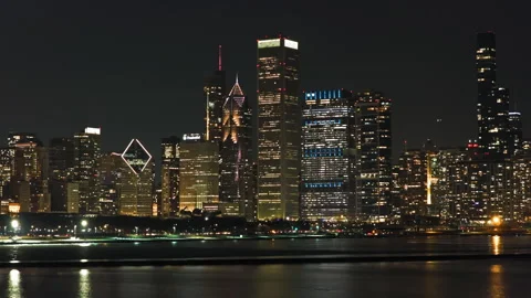 Aerial telezoom of Chicago Loop skyline and Lake Michigan Waterfront at night Stock Footage 332686894