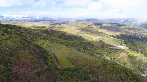 Aerial of terraced and patchwork fields under cloudy sky Stock Footage 79679771