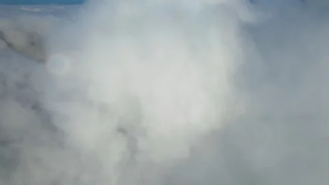 Aerial Thick White Clouds Drifting Over Mountain Peaks in Daylight Stock-Footage 342250955
