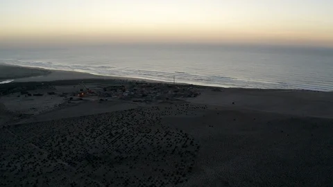 An aerial of a thin road bisecting a beautiful barren desert and jagged hills. Stock Footage 127043237
