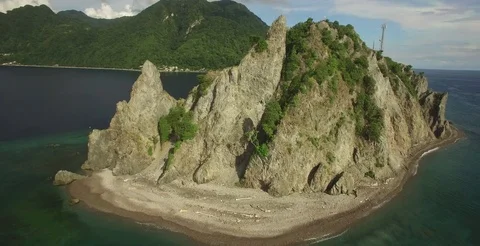 Aerial threads the needle between rock formation to reveal Bay of Soufriere 스톡 동영상 70016543