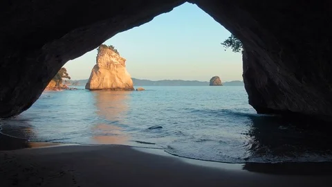 Aerial through cave over ocean At Cathedral Cove, New Zealand Stock Footage 120592820