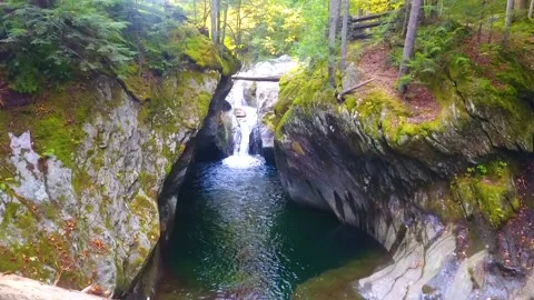 Aerial through fall narrow gorge in Vermont with stunning waterfall raging Stock Footage 225780947