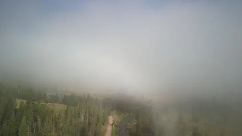 Aerial through low clouds in Madison Range in Montana in summer in early morning Stock Footage 282673238