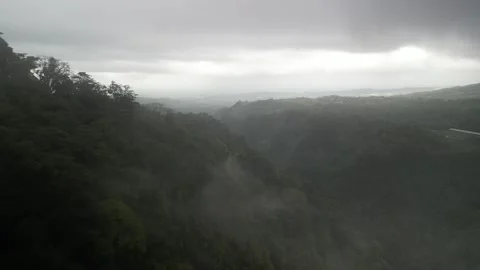 Aerial through low mist over steep jungle hillsides Costa Rica cloud forest Stock Footage 330214871