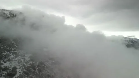 Aerial through puffy low cloud plume in mountain landscape in Colorado Stock Footage 239781316