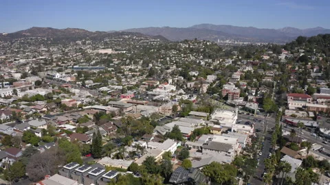Aerial through Silver Lake’s Sunset Junction, reveal Hollywood Sign Stock Footage 133699659