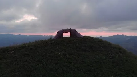 Aerial through a tent during sunset on a mountain in Switzerland. Stock Footage 130538636