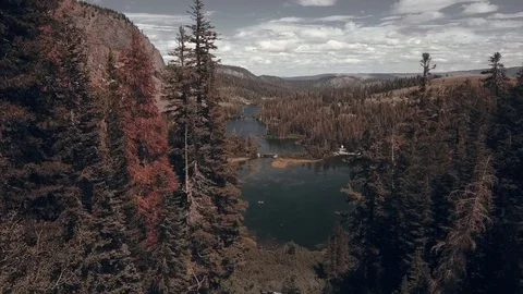 Aerial through the trees to reveal Upper and Lower Twin Lakes in Mammoth Lake Stock Footage 91305585