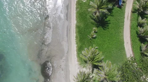 Aerial of tide hitting small beach Stock Footage 66338519