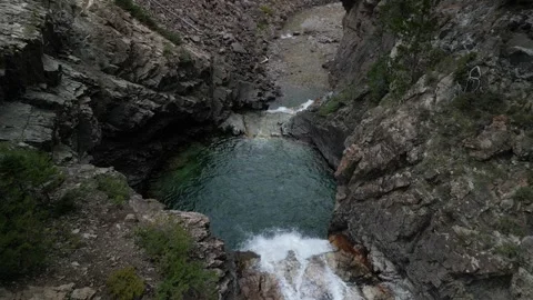 Aerial tilt down on Devils Punchbowl waterfall in Crested Butte Colorado Stock Footage 250953509