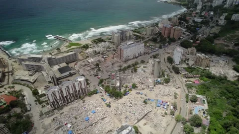 Aerial tilt down drone view of collapsed buildings and emergency rescue Stock Footage 341431628