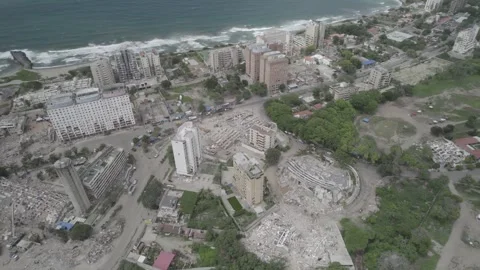 Aerial tilt down drone view to zenith perspective of collapsed buildings and Stock Footage 342003308
