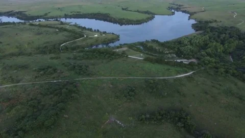 Aerial tilt down to field with dirt road going through Stock Footage 80270848