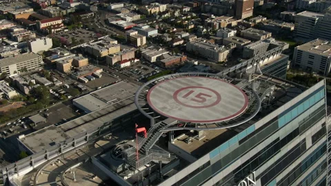 Aerial: Tilt Down Flyover of Skyscraper Rooftop - Los Angeles, California Stock-Footage 149296944