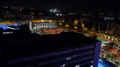 Aerial tilt down movement to modern parking building at night Video stock 71103572