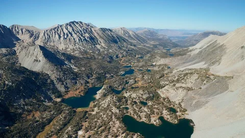 Aerial tilt down shot of Eastern Sierra alpine lakes, mountains in California Stock Footage 122843915