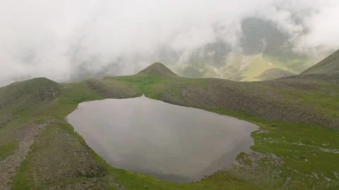 Aerial tilt down view alpine Sakori lake in country of Georgia. Hiking trek.. Stock Footage 309329234