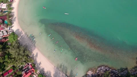 Aerial Tilt-Down View of Koh Phangan: Clear Waters, Boats, and Sandy Beache Stock Footage 278286989