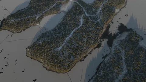 Aerial Tilt Up Drone Flight Over Rural Area With Cabins At Frozen Lake Stock Footage 224295512
