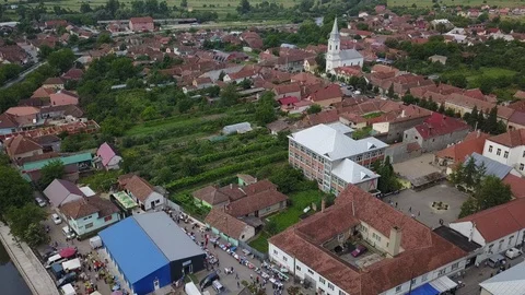 Aerial Tilt Up While Flying Over Eastern European Town With White Church 스톡 동영상 102448869