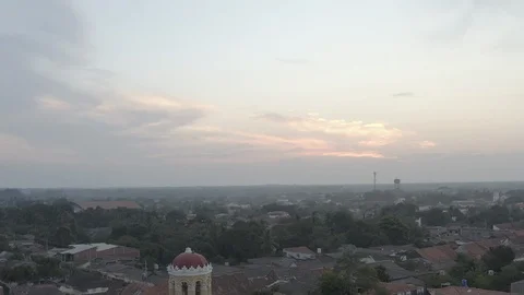 Aerial tilts down from sunset to Santa Barbara church in Mompox, Colombia Stock-Footage 108820720