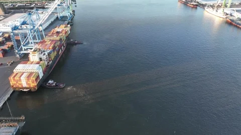 Aerial Time Lapse of a Cargo Ship Being Turned Around Stock Footage 240694939