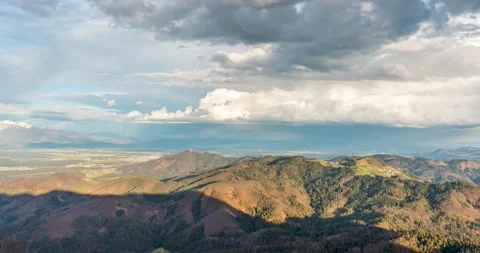 Aerial time lapse of clouds moving over the hills Stock Footage 237987588
