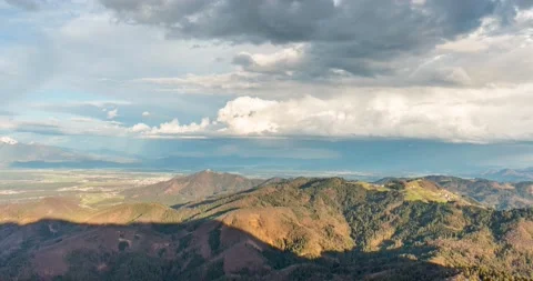 Aerial time lapse of clouds moving over the hills Stock Footage 237987604