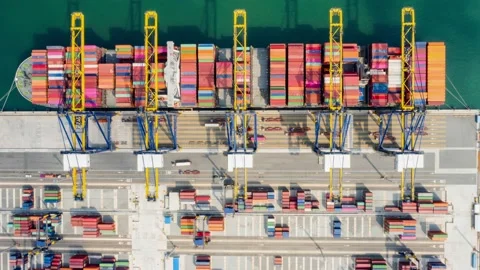 Aerial Time-lapse. Container ship loading in the harbor with bridges Crane Op Vidéo 171577610