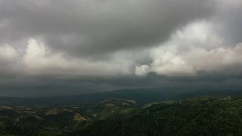 Aerial time lapse of developing clouds, over hills Stockbeeldmateriaal 205507466