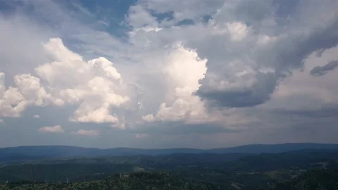 Aerial time lapse of developing storm clouds, over hills Stockbeeldmateriaal 205507581