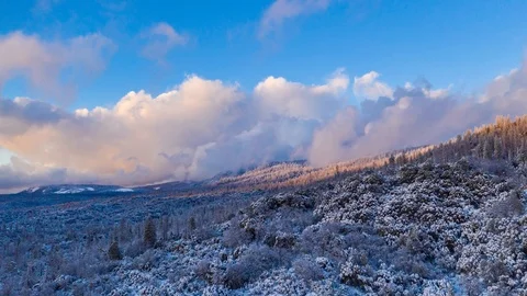 Aerial time lapse flying forward over a snow covered landscape in winter. Video stock 102812043