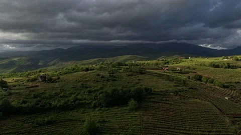 Aerial time lapse of low clouds moving over rugged mountain hills Stock Footage 338415457
