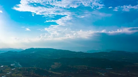 Aerial Time Lapse of Rolling Cloud Sea Above Mountains Under Clear Blue Sky Stock Footage 341876143