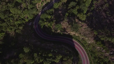 Aerial time lapse shot of sharp curve road in the mountain Stock Footage 76915312