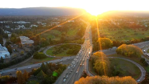 Aerial time lapse at sunset over the mountains above a freeway and golf course Stock Footage 99667378