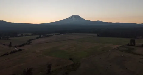 Aerial time lapse of sunset over mountain and fields Stock Footage 165258850