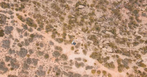 Aerial time lapse top down view of solo camper in van and tent boondocking Stock Footage 237451218