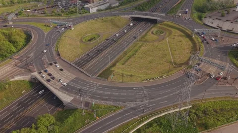 Aerial Time Lapse of Traffic Flow on Motorway Roundabout and Highway Stock Footage 334007926