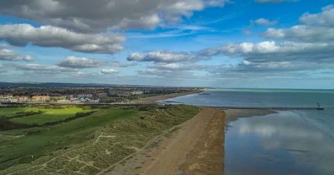 Aerial time lapse view of a beach and the mouth of a river in Southern England Stock Footage 80889372