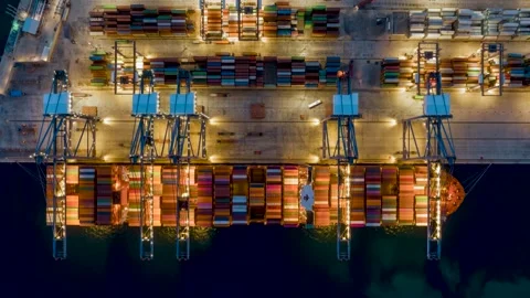 Aerial time lapse view of large container cargo ship being unloaded by cranes Video stock 261402257