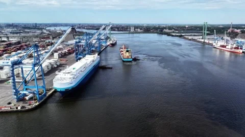 Aerial Timelapse Cargo Ship Docking at Port and a Vehicle Carrier Ship Departing Stock Footage 248948228