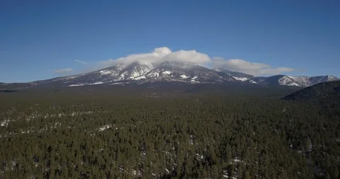 Aerial timelapse of clouds boiling and rolling over snowy mountain peaks Stock Footage 101617034